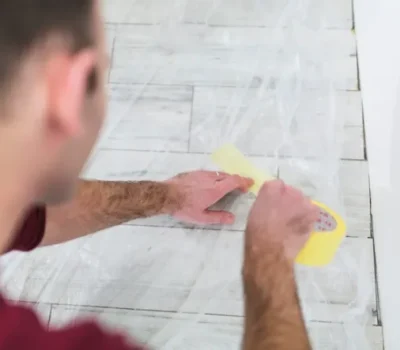crop-man-protecting-floor-with-sheet_23-2147782335